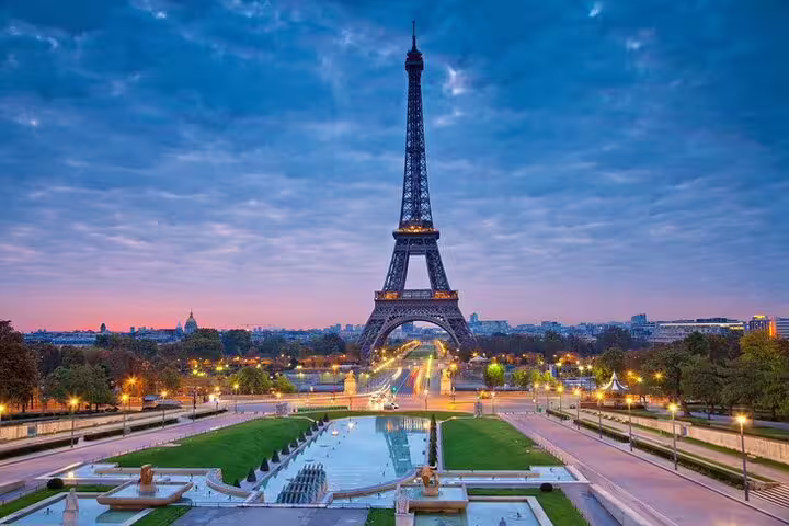 Eiffel Tower at dusk with illuminated fountains and gardens in Paris, France