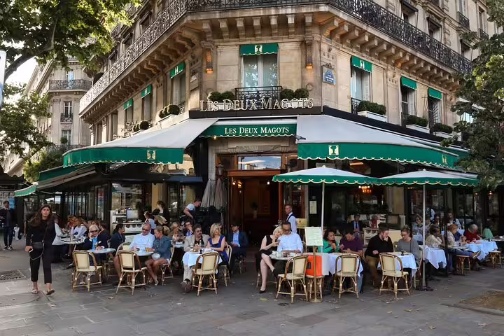 Visitors enjoying outdoor dining at the iconic Les Deux Magots café in Paris, a must-see on a private city highlights tour.