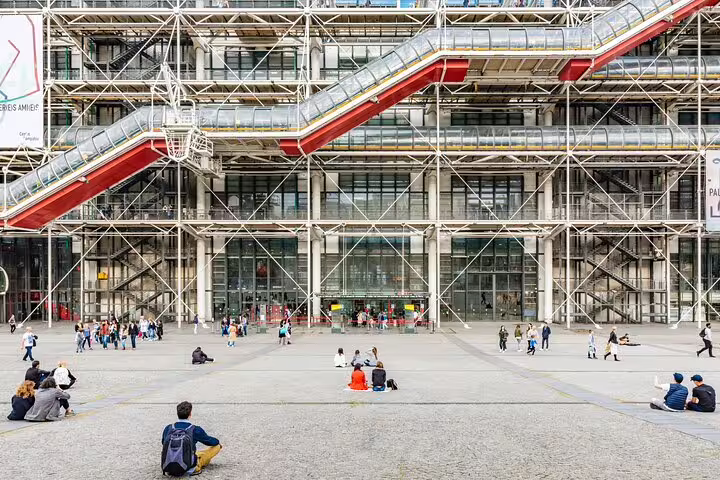 Visitors relaxing at the vibrant exterior of the Pompidou Center in Paris, a stop on the private tour with Louvre entry and crepes.