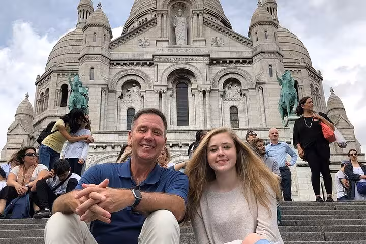 Travelers on Sacré-Cœur steps in Montmartre on a Paris half-day private customized walking tour with transport