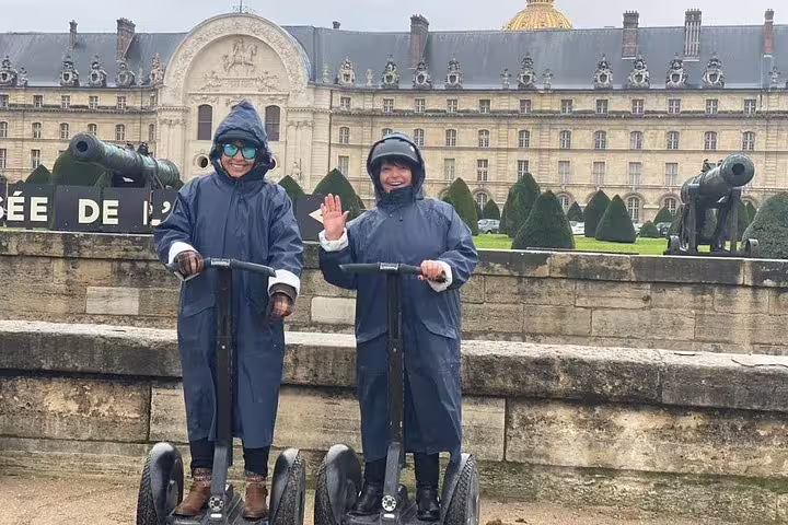 Segway riders in rain gear at Les Invalides on a Paris Segway tour, paired with Seine River cruise ticket