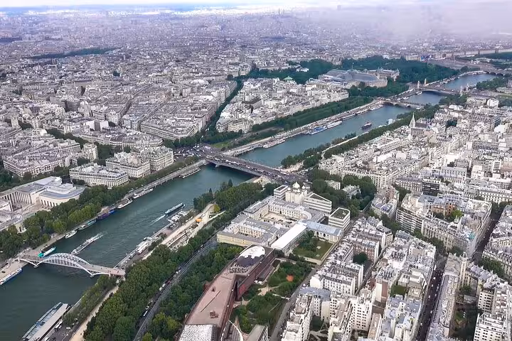 Aerial view of Paris Seine River cruise route near Louvre and city landmarks on half-day highlights tour