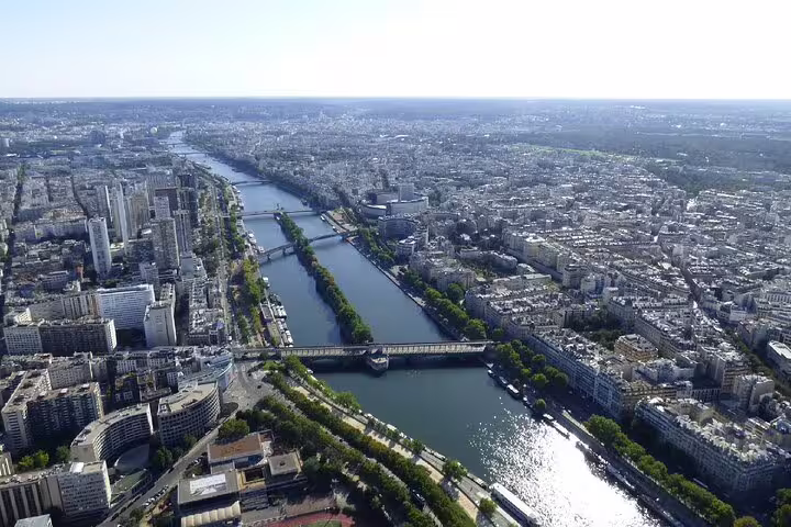 Aerial view of Paris cityscape and Seine River with multiple bridges seen from Eiffel Tower summit
