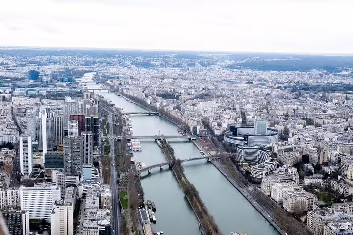 Aerial view of Paris and the Seine River with multiple bridges seen from the Eiffel Tower top floor