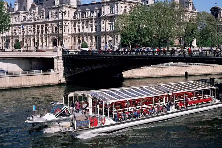 Bateaux Mouches river cruise boat on the Seine River with Hôtel de Ville in background, Paris