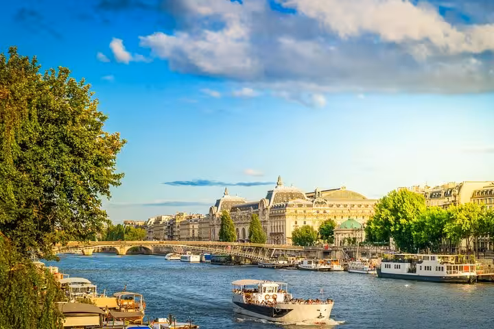 Seine River cruise boats by Paris landmarks, included with Full Day Paris City Pass hop-on hop-off access