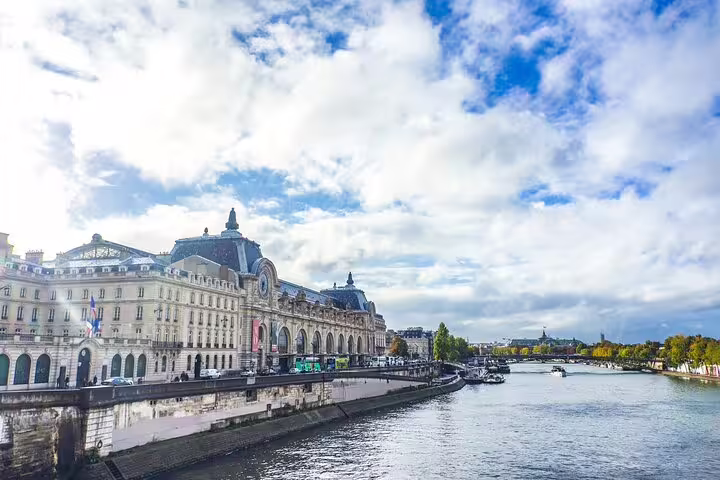 Musée d'Orsay along the Seine River in Paris under a cloudy sky