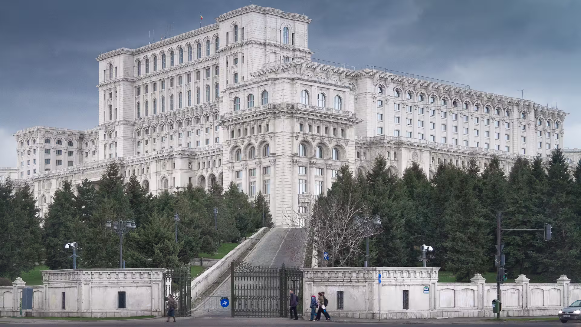 Front view of Parliament Palace in Bucharest framed by trees, perfect for exploring with fast-track tickets and guide.