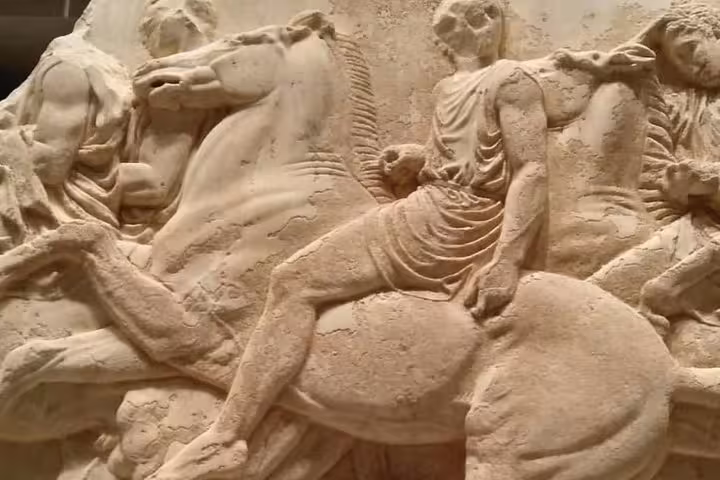 Close-up of Parthenon frieze horsemen relief at Acropolis, Athens, on guided walking tour