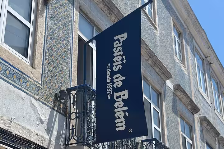 Pastéis de Belém sign on a traditional tiled building, iconic pastry shop in Lisbon since 1837.