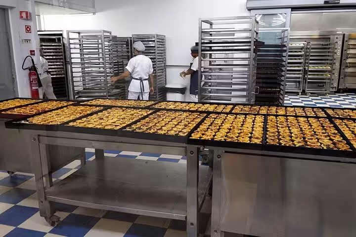 Pastéis de Belém baking trays in the kitchen, included tasting on a private Belém tuk tuk tour