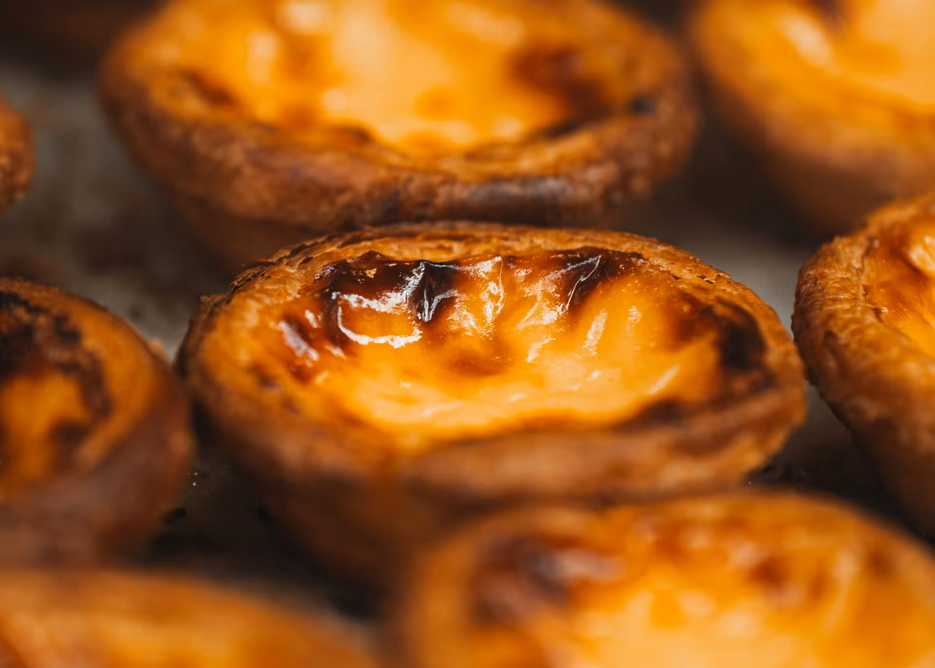Freshly baked golden Pasteis de Belem custard tarts a delicious local treat enjoyed during the Lisbon and Belem e-bike tour