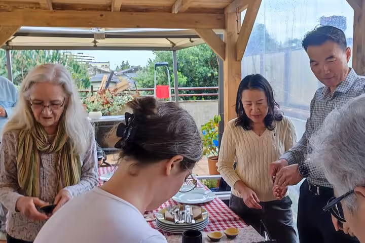 Guests enjoying Pastel de Nata on a cozy terrace, capturing moments of a flavorful tour experience.