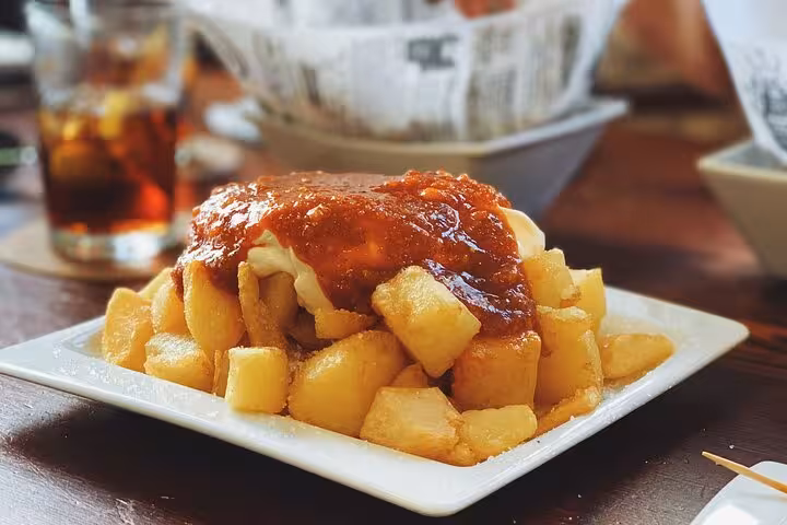 Patatas bravas with spicy tomato sauce, a classic tapas tasting on the Valencia gourmet tour by bike or on foot