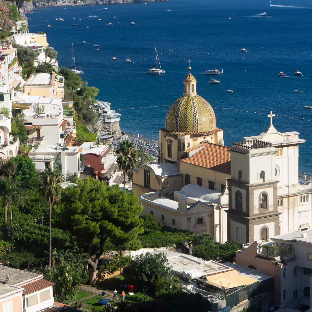View of Positano and Church of Santa Maria Assunta dome above the Amalfi Coast, seen from the Path of the Gods trek