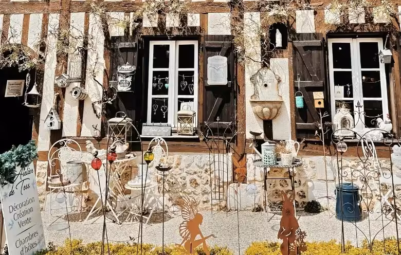 Half-timbered Pays d'Auge cottage shopfront near Le Havre, Normandy day tour with rustic decor and garden