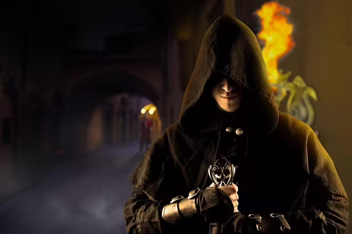 Hooded mysterious figure holding ornate artifact with flames at night in Florence