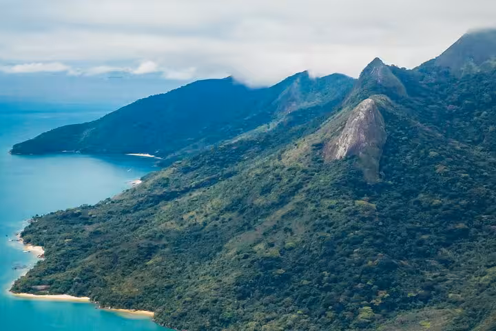 Breathtaking view of Peak Sugar Bread's lush green mountains and coastline for adventure seekers.