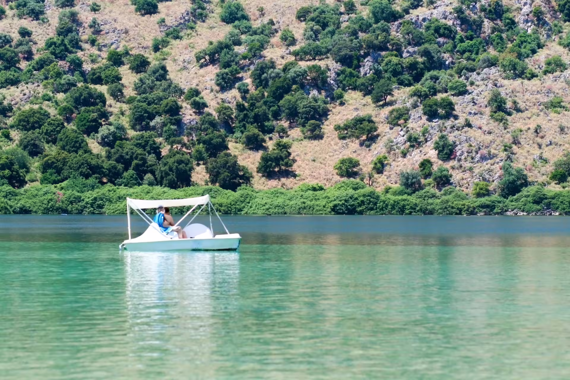 Pedal boat on calm Lake Kournas in Crete, relaxing stop on Best of Chania sights full-day private tour