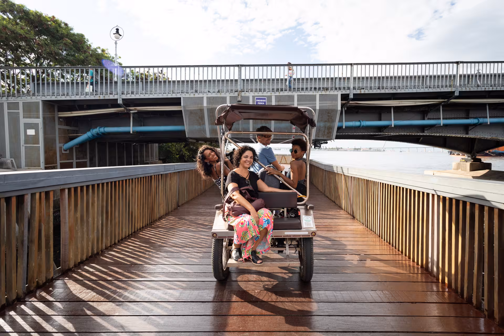 Group rides a pedicab along Rio de Janeiro waterfront on a historical city centre tour near downtown bridges