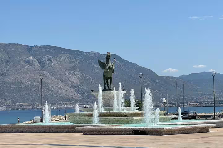 Pegasus fountain on Nafplio waterfront with mountains, scenic stop on Corinth Canal and olive oil tasting tour