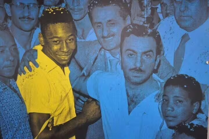 Historic photo of Pelé celebrating with fans, highlighting his football legacy on the 5-hour Pelé Private Tour.