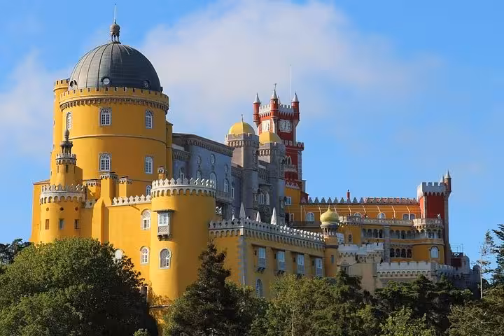 Vibrant Pena National Palace in Sintra with colorful turrets and lush greenery, perfect for private tours from 1 to 8 people.
