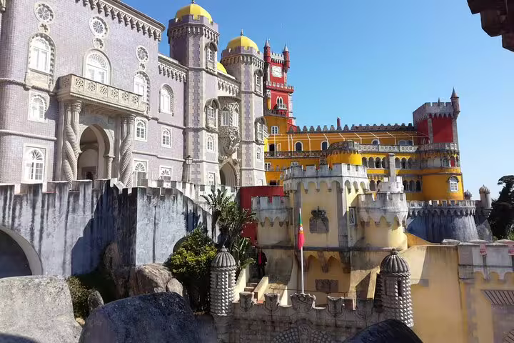 Close-up of the intricate architecture of Pena Palace, showcasing vibrant facades and detailed stonework in Sintra.