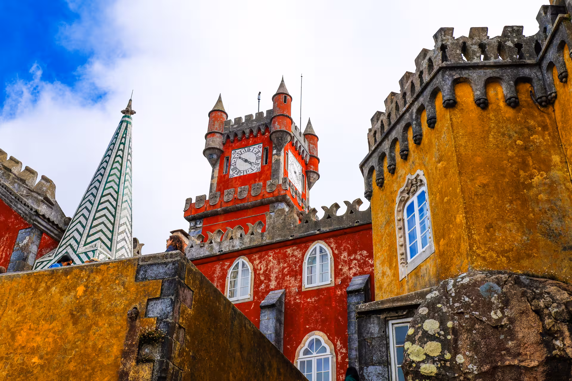The colorful turrets and clock tower of Pena Palace in Sintra, a highlight of the Lisbon day tour.