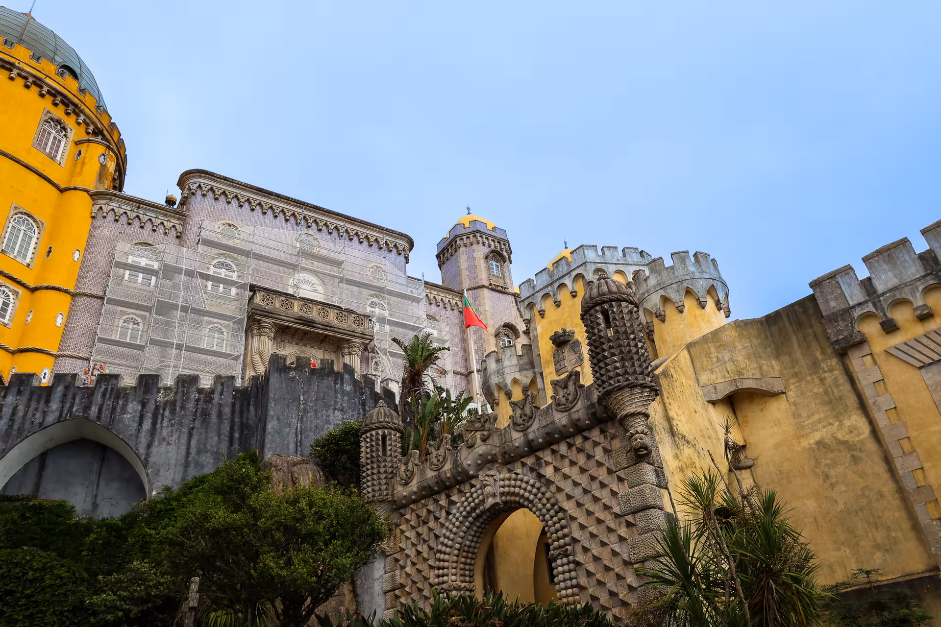 The vibrant architecture of Pena Palace in Sintra showcases its colorful towers and detailed carvings, a must-see on the Lisbon day tour.