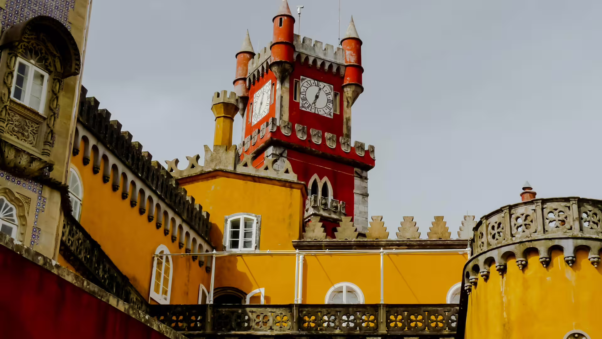 Colorful Pena Palace in Sintra showcases vibrant architecture, a must-see on the Lisbon Sintra Cascais Roca Cape tour.