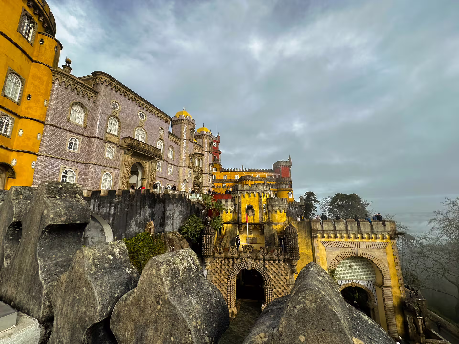 Stunning view of Pena Palace's vibrant architecture and scenic surroundings in the hills of Sintra, Portugal.