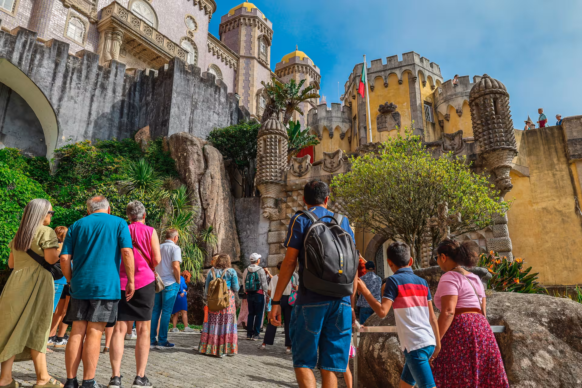 Tourists exploring the vibrant and historic architecture of Pena Palace in Sintra, Portugal.