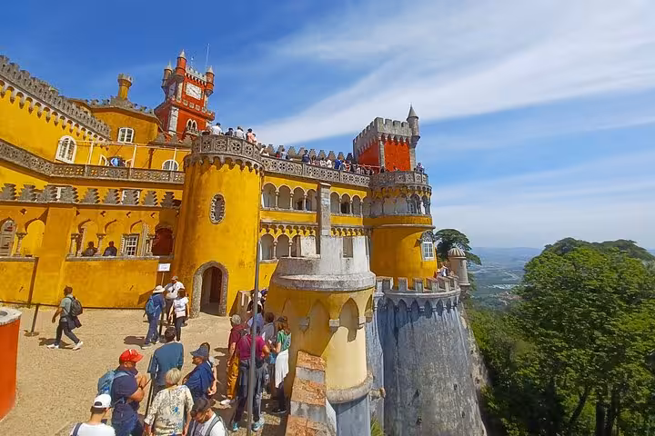 Pena Palace Sintra terraces with visitors and panoramic views, highlight of tuk tuk tour to Cascais coast