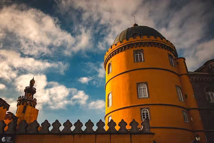 Yellow tower of Pena Palace, Sintra, Portugal, dramatic sky highlight for self-drive monuments and coast tour