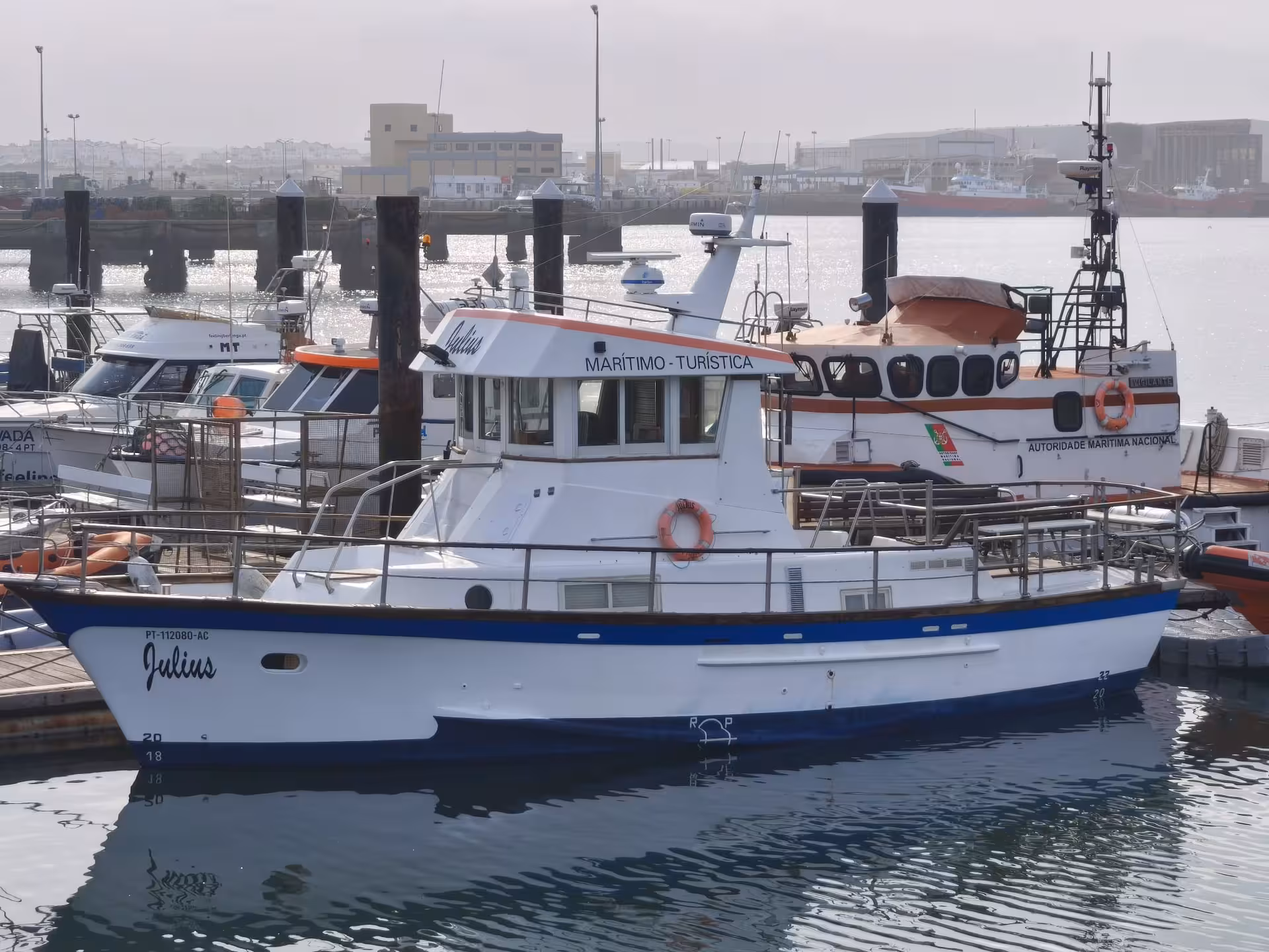 Peniche marina tour boat ready for Berlengas Islands cruise, maritime tourism vessel docked in Portugal