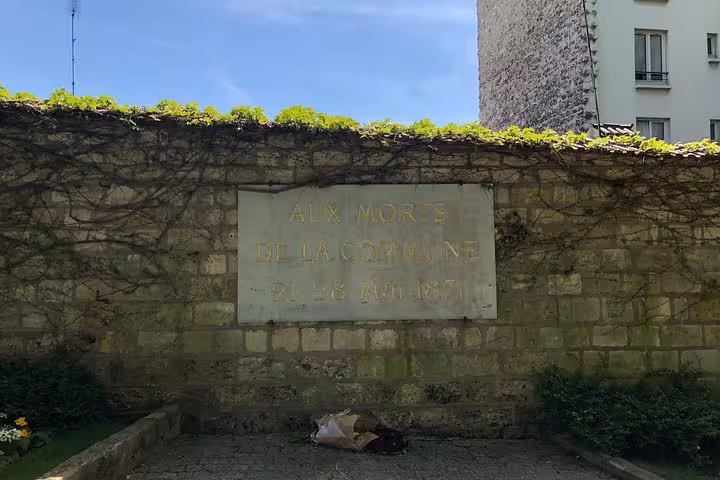 Stone memorial plaque at Père Lachaise Cemetery inscribed 'Aux Morts de la Commune 21-28 Mai 1871'