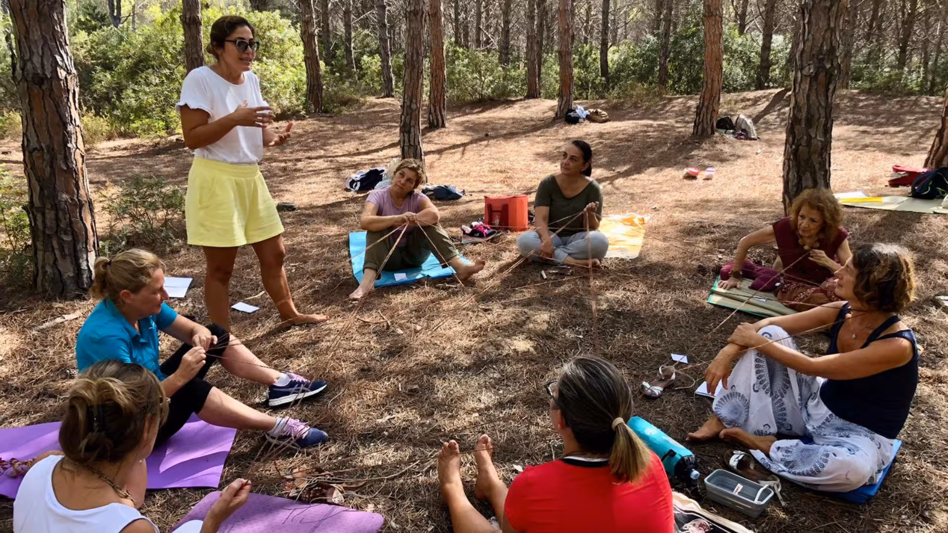 Participants engage in green mindfulness activities in a tranquil forest setting during the Perfugas experience.
