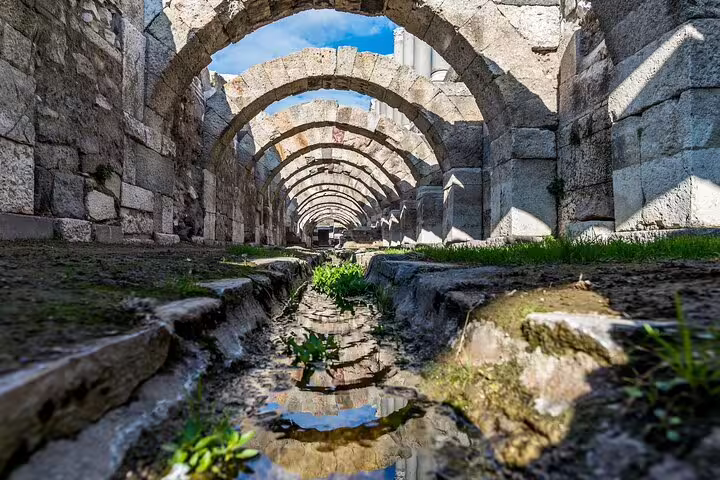 Stone-arched tunnel at ancient Pergamon, dramatic ruins view on 4-day small-group tour from Kusadasi to Istanbul