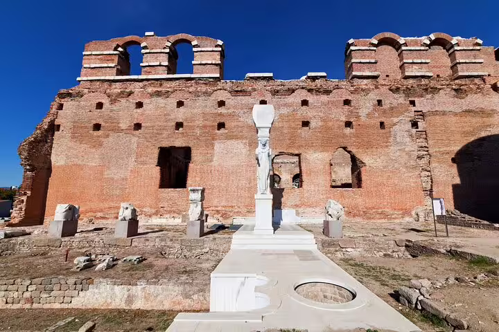 Explore the ancient ruins of Pergamon with a stunning view of the Red Basilica under a clear blue sky.