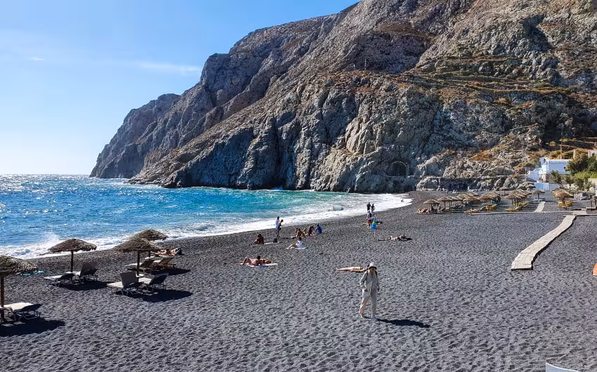 Perissa black sand beach and dramatic cliffs stop on a semi-private Santorini panoramic island tour