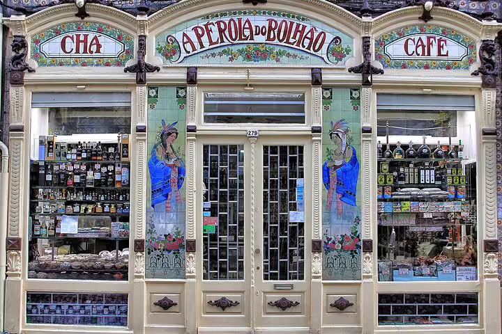 Colorful facade of A Pérola do Bolhão shop in Porto, ideal stop on a half-day private TukTuk tour featuring art nouveau design.