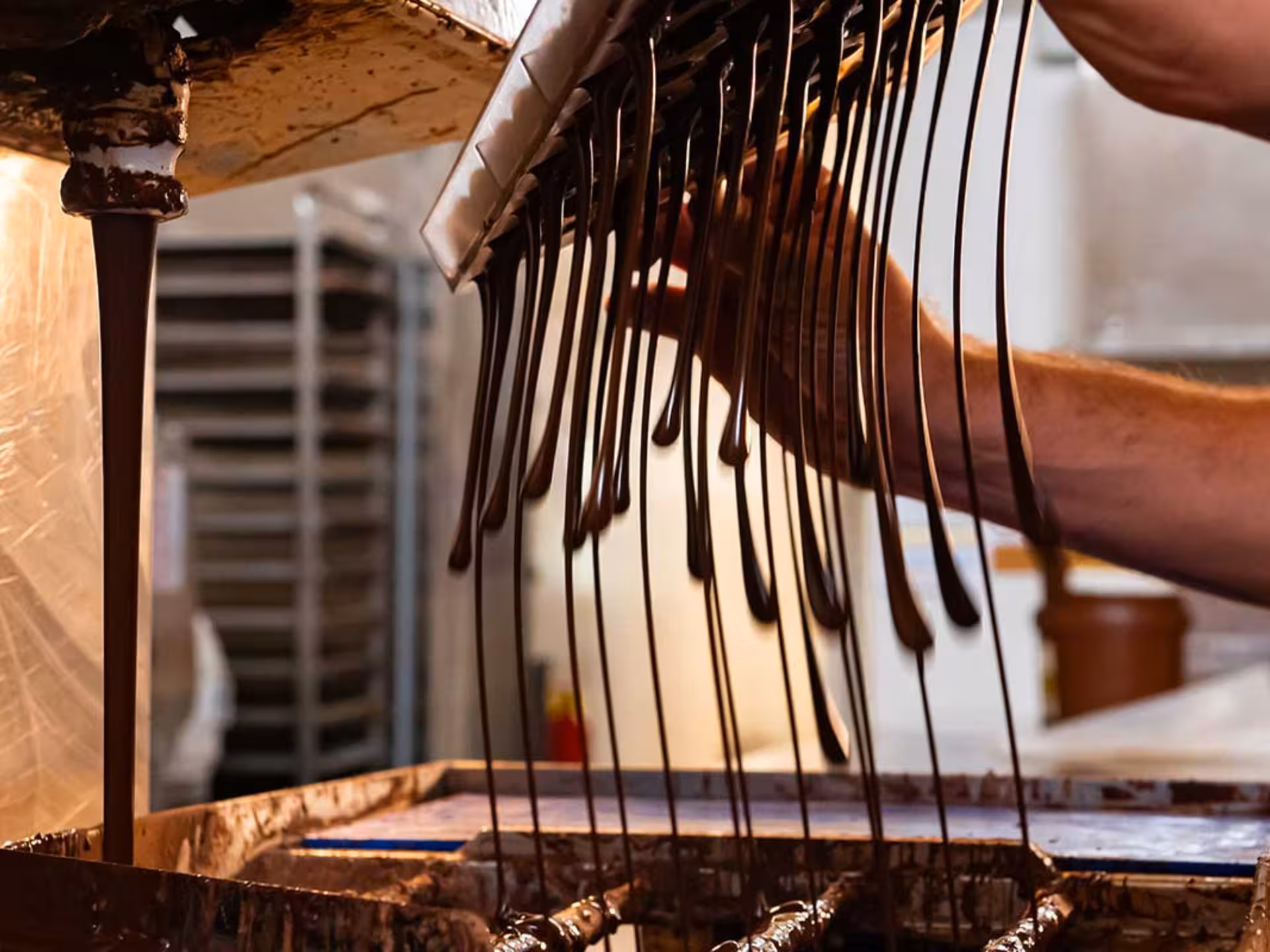 Close-up of chocolate production process, showcasing hands-on experience during the Perugia Chocolate Factory Tour.
