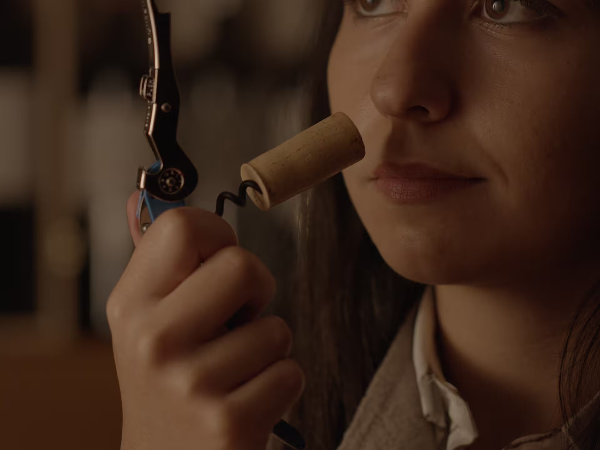 Guest smelling wine cork during Perugia winery visit and tasting near Lake Trasimeno in Umbria, Italy