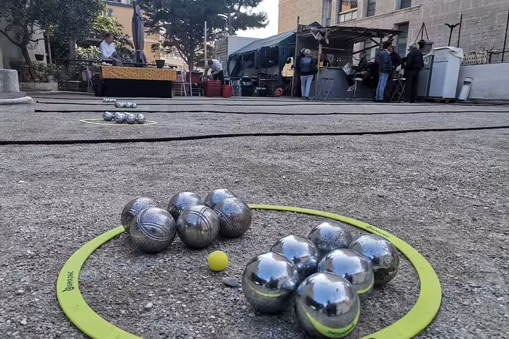 Petanque boules and jack on a Marseille court, classic French game during a guided petanque tour