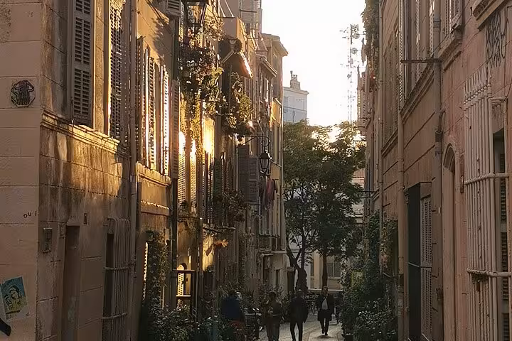 Golden hour in Le Panier, Marseille old town alley, atmospheric backdrop for a petanque experience