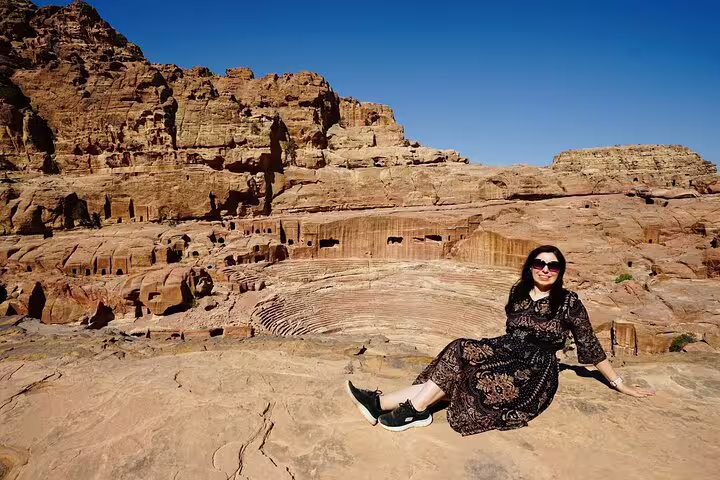 Traveler at Petra Roman Theatre viewpoint, Jordan highlight on 13-day Egypt Jordan tour with flights Cairo to Amman