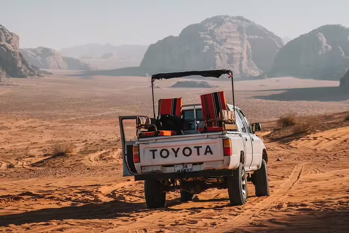 4x4 desert jeep in Wadi Rum-style landscape en route to Petra from Taba by ferry, Jordan day trip adventure