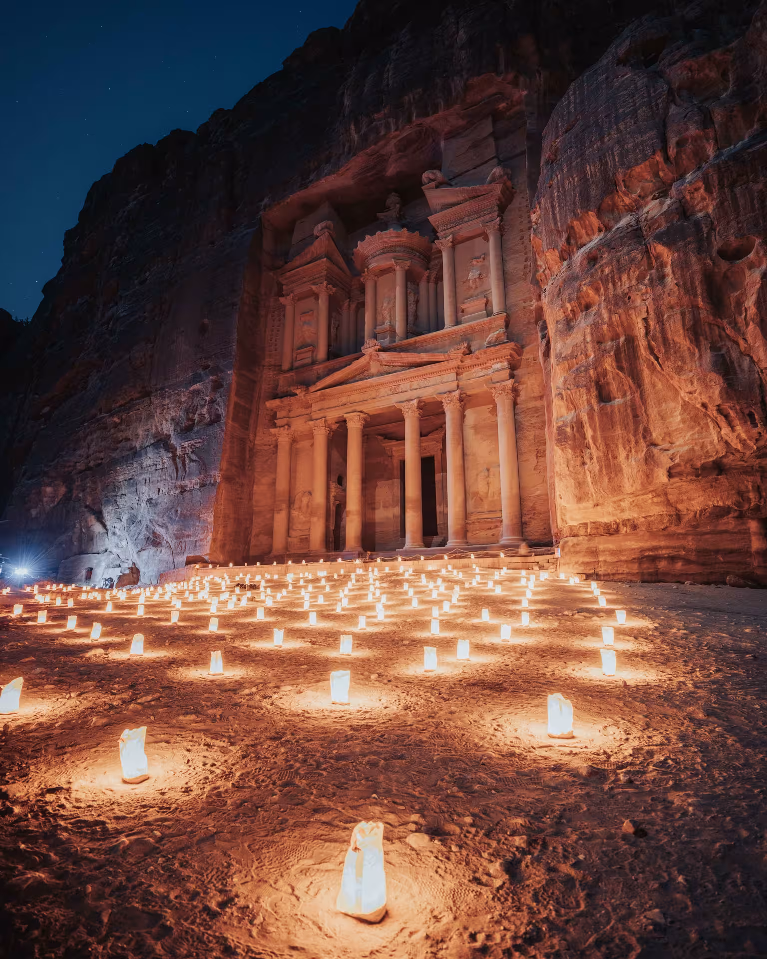 Petra Treasury at night lit by hundreds of candles during Petra by Night, a must-see on the Timeless Jordan tour