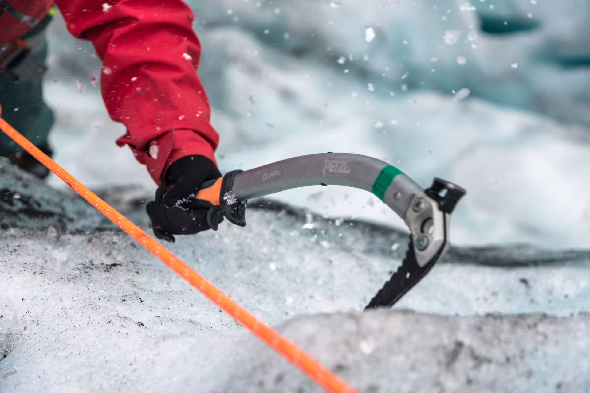 Climber using Petzl Quark ice axe on glacier surface during ice climbing in Skaftafell